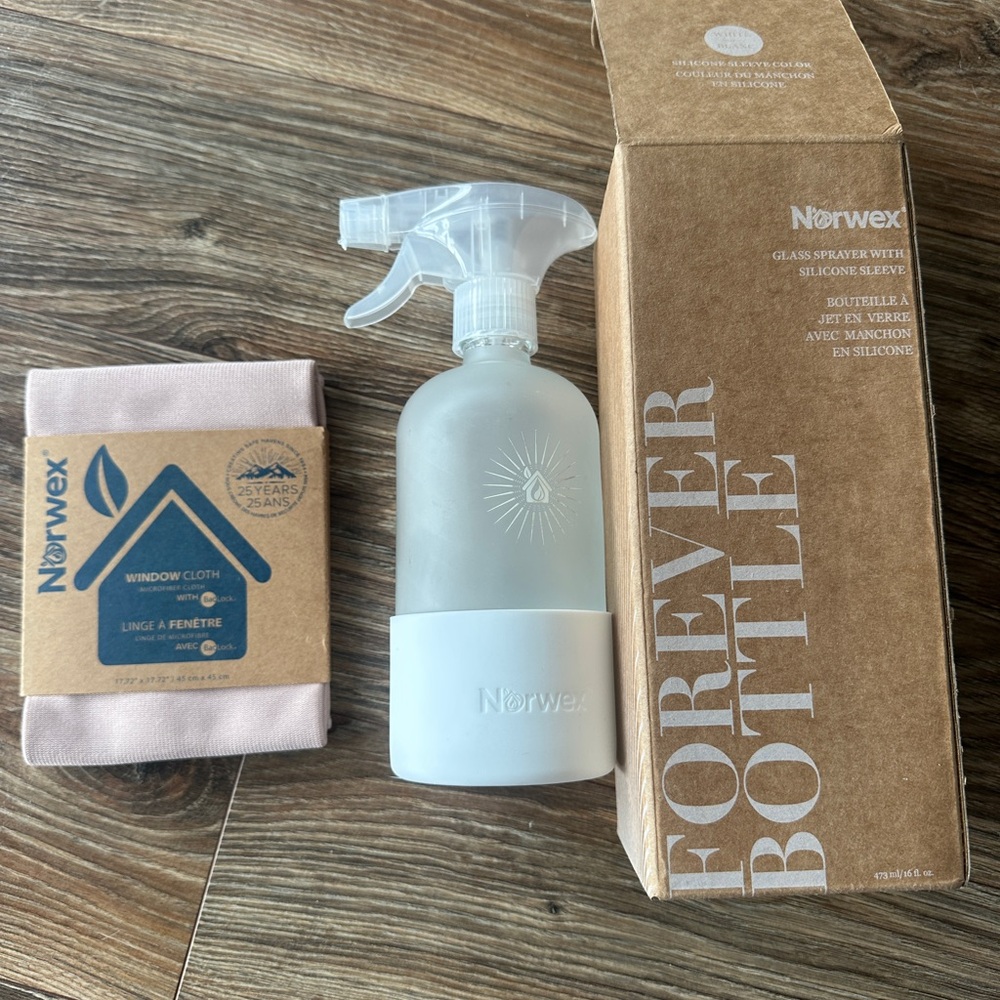 Norwex Frosted Glass Spray Bottle with White Sleeve and Beige Window Cloth